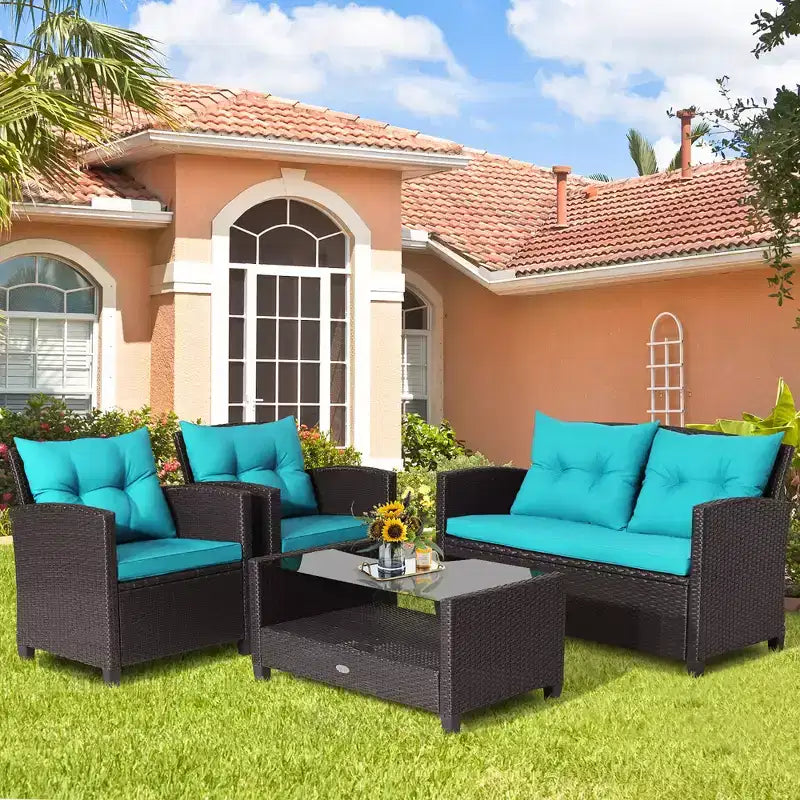 Set di mobili da giardino in rattan a 4 pezzi Costway con tavolo in vetro, scaffale e cuscini per divano